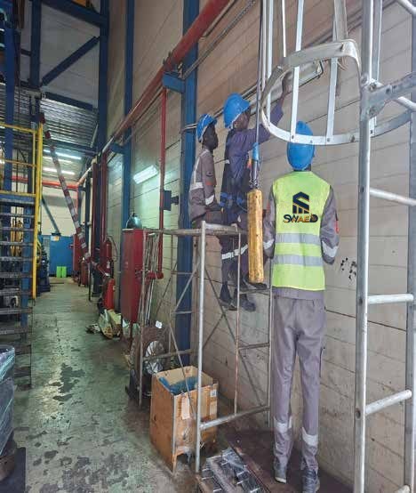 SWAED technician on scaffolding inside a process facility