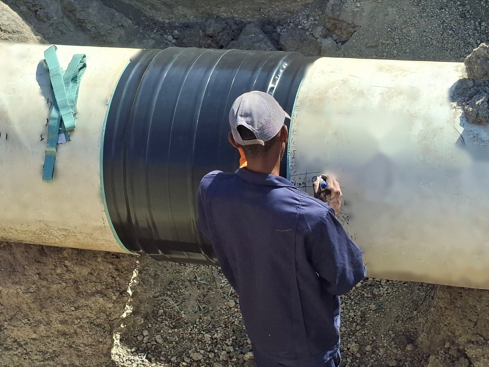 Technician recording repair data beside newly applied coating