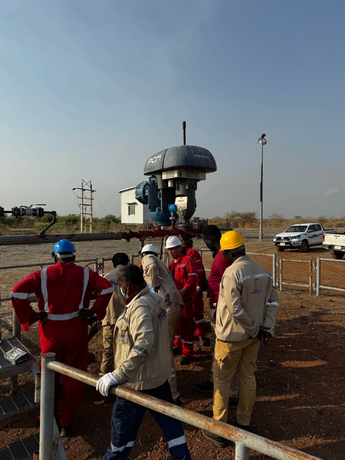 Team gathered at a wellhead during tie-in works