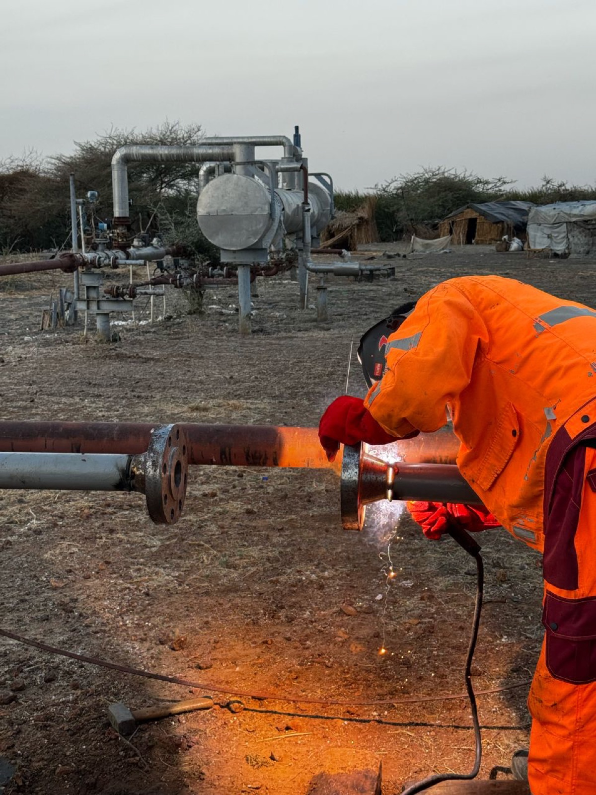 Welder cutting pipe at the water disposal line