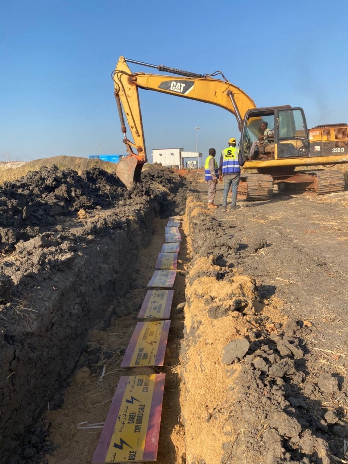 Excavator working along a trench line