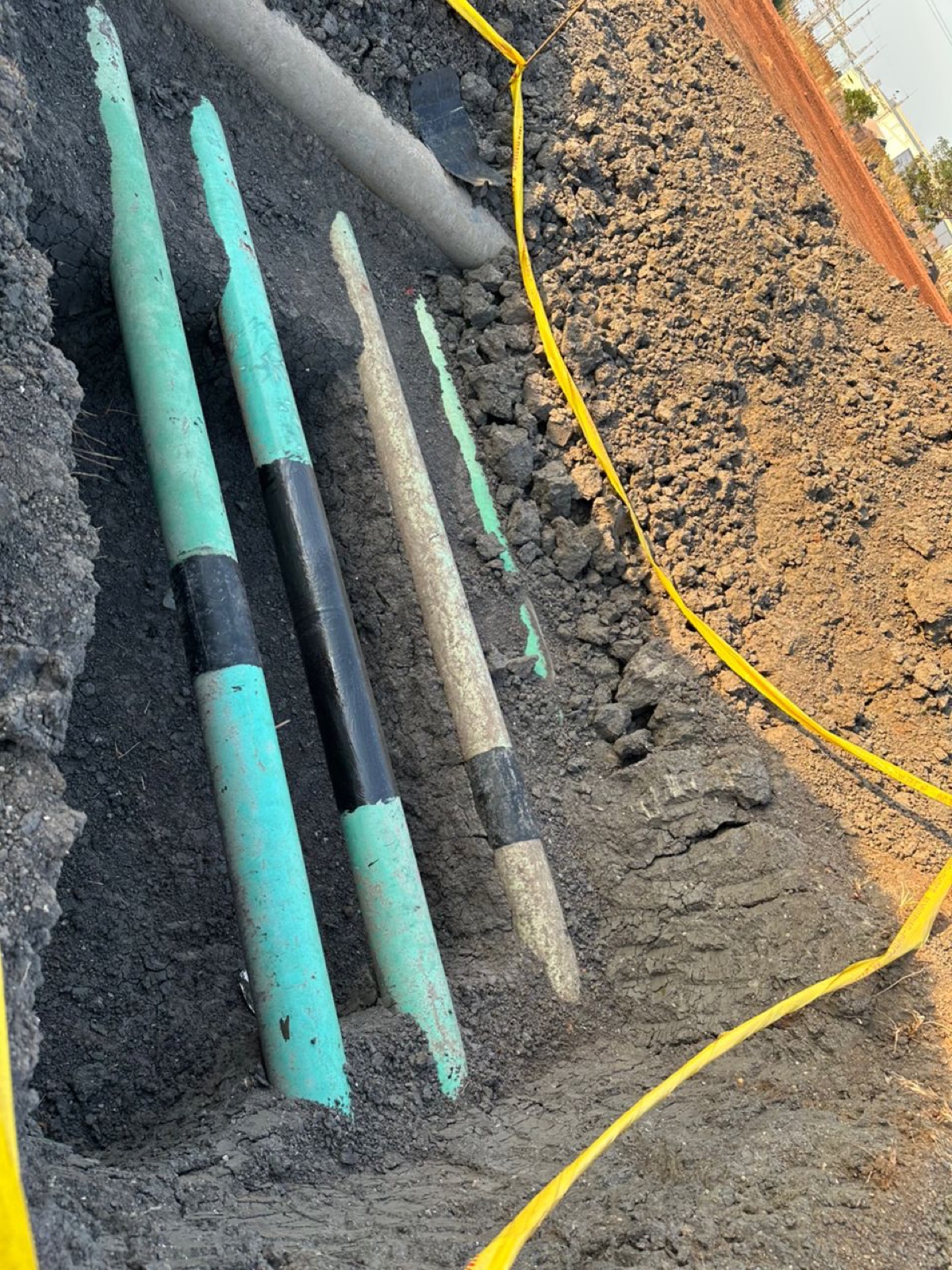 Repaired flowlines with fresh coating ready for backfill