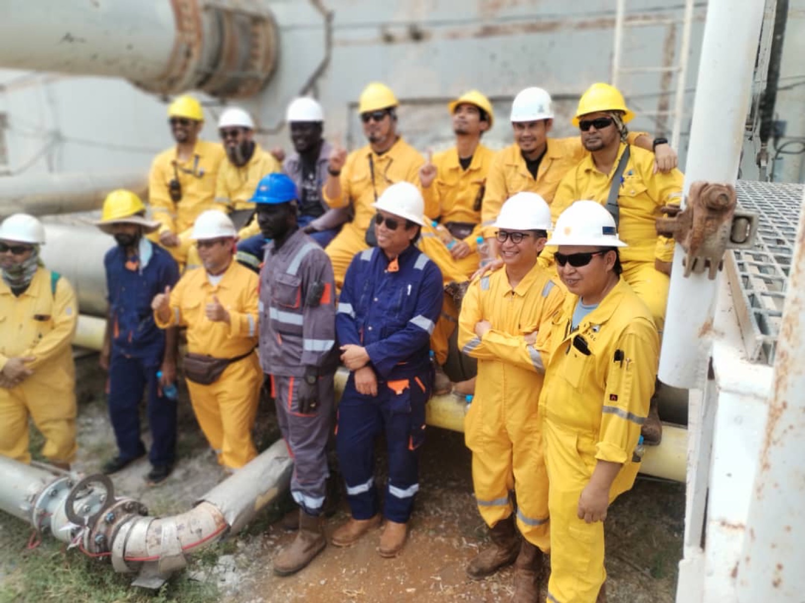 SWAED team beside tank piping